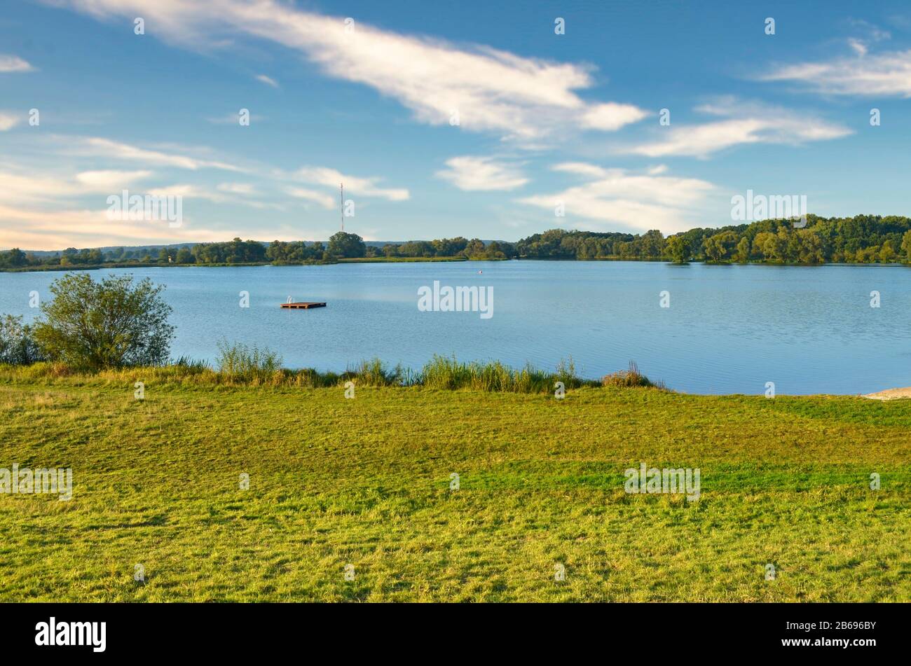 View to the Gartower Lake in Lower Saxony, Germany, under a blue sky. Stock Photo