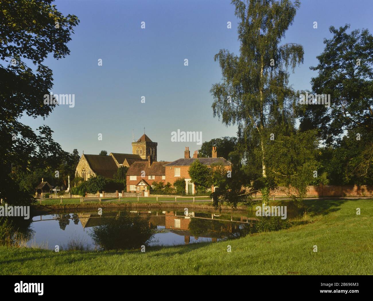 Chiddingfold village pond and St Marys Church, Surrey, England, UK