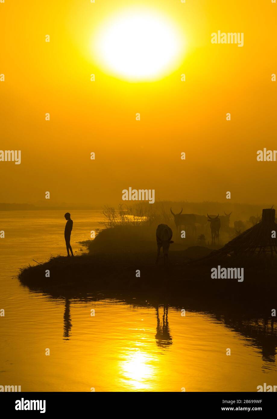 Mundari tribe child on the bank of river Nile at sunset, Central Equatoria, Terekeka, South Sudan Stock Photo