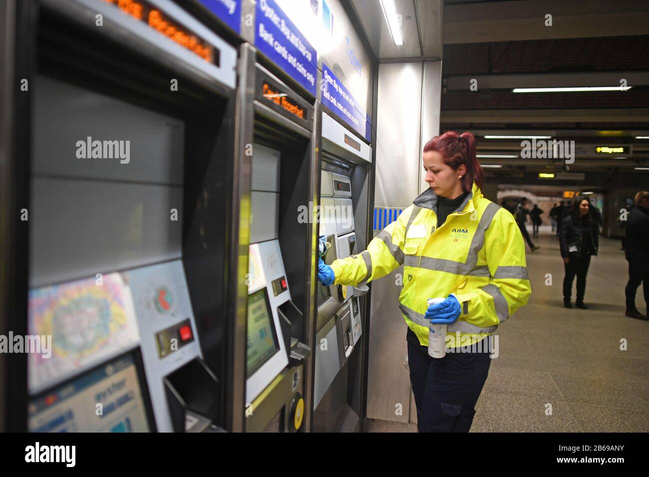 A member of staff at London Bridge station undertakes enhanced cleaning procedures that Transport for London (TfL) have introduced across the network in an effort to prevent the spread of coronavirus. Stock Photo