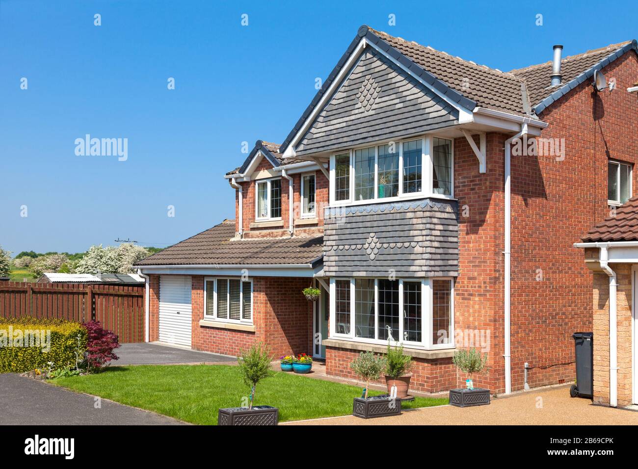 Elegant english detached house with front garden Stock Photo - Alamy