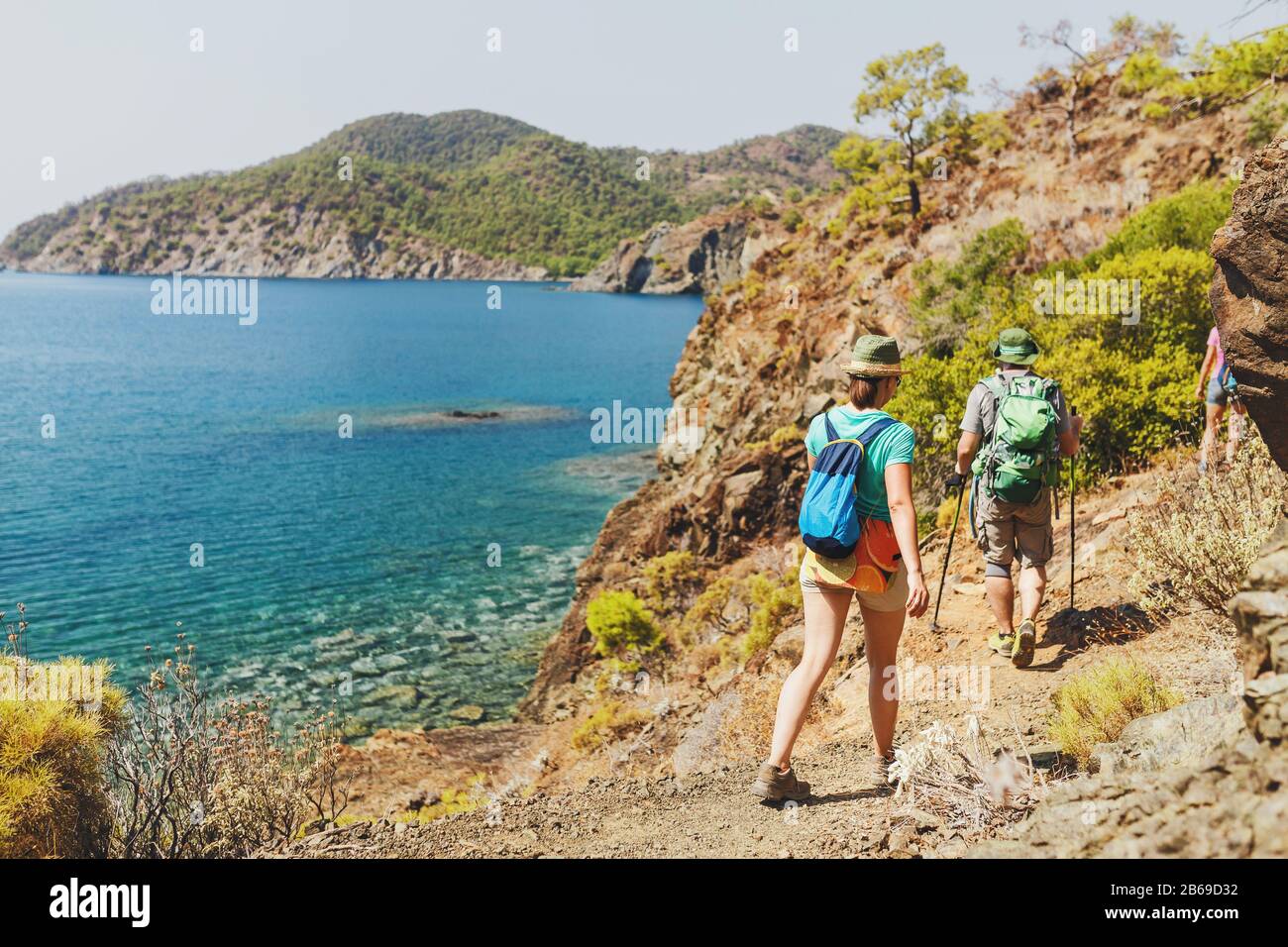 Group of Hikers walking by Lycian Way trail along wild beach and mountains in Turkey Stock Photo