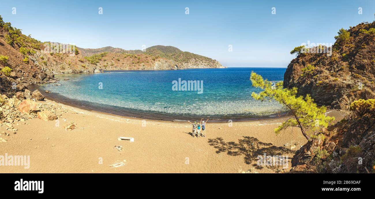 Group of young people having fun and hugging on the beach together. Vacation with friends in Turkey concept Stock Photo