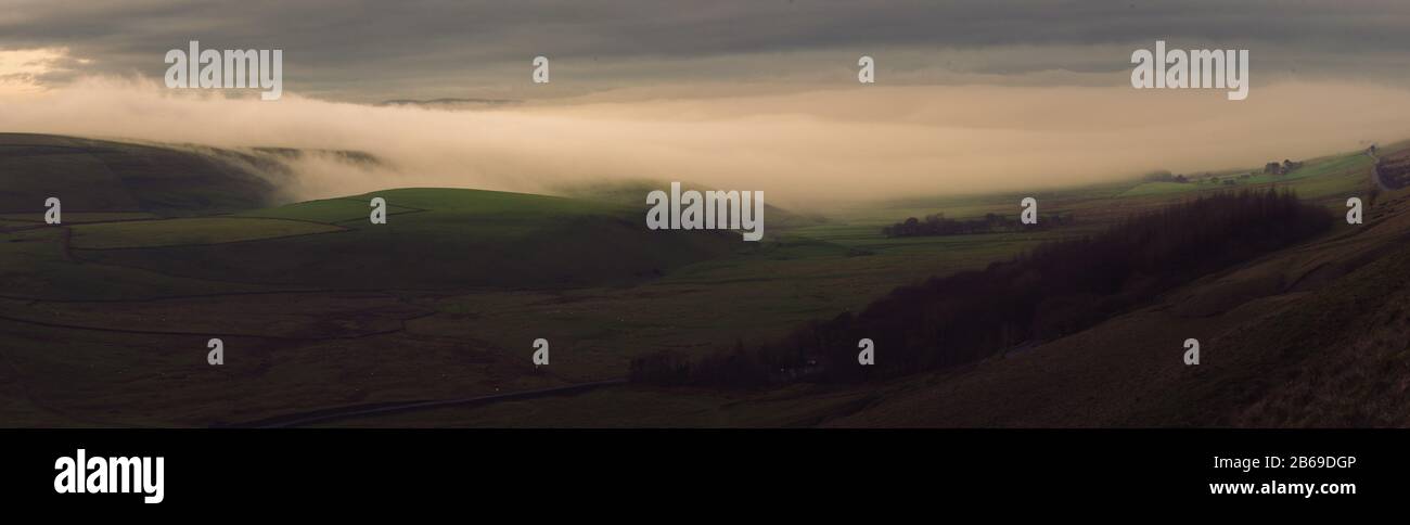 Stunning cloud inversion panorama in the Peak District National Park during sunrise Stock Photo
