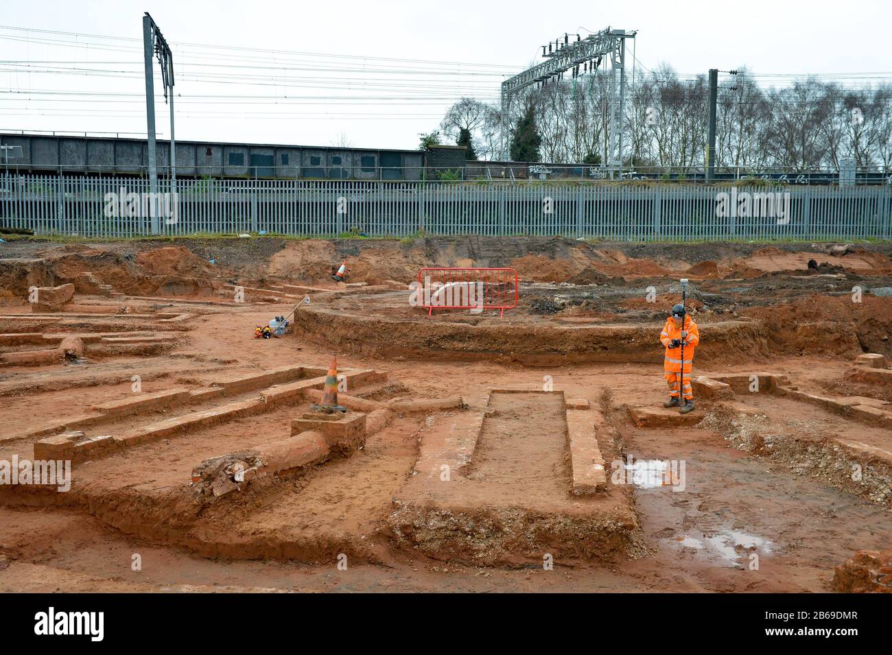 Archaeologists work at the site of a 19th century roundhouse which has been unearthed during the excavation work for HS2 on the site of the former Birmingham Curzon Street railway station, which opened in 1838. Trial trenching on the construction site has revealed the remains of the station's roundhouse including evidence of the central turntable, the exterior wall and the radial inspection pits. Stock Photo