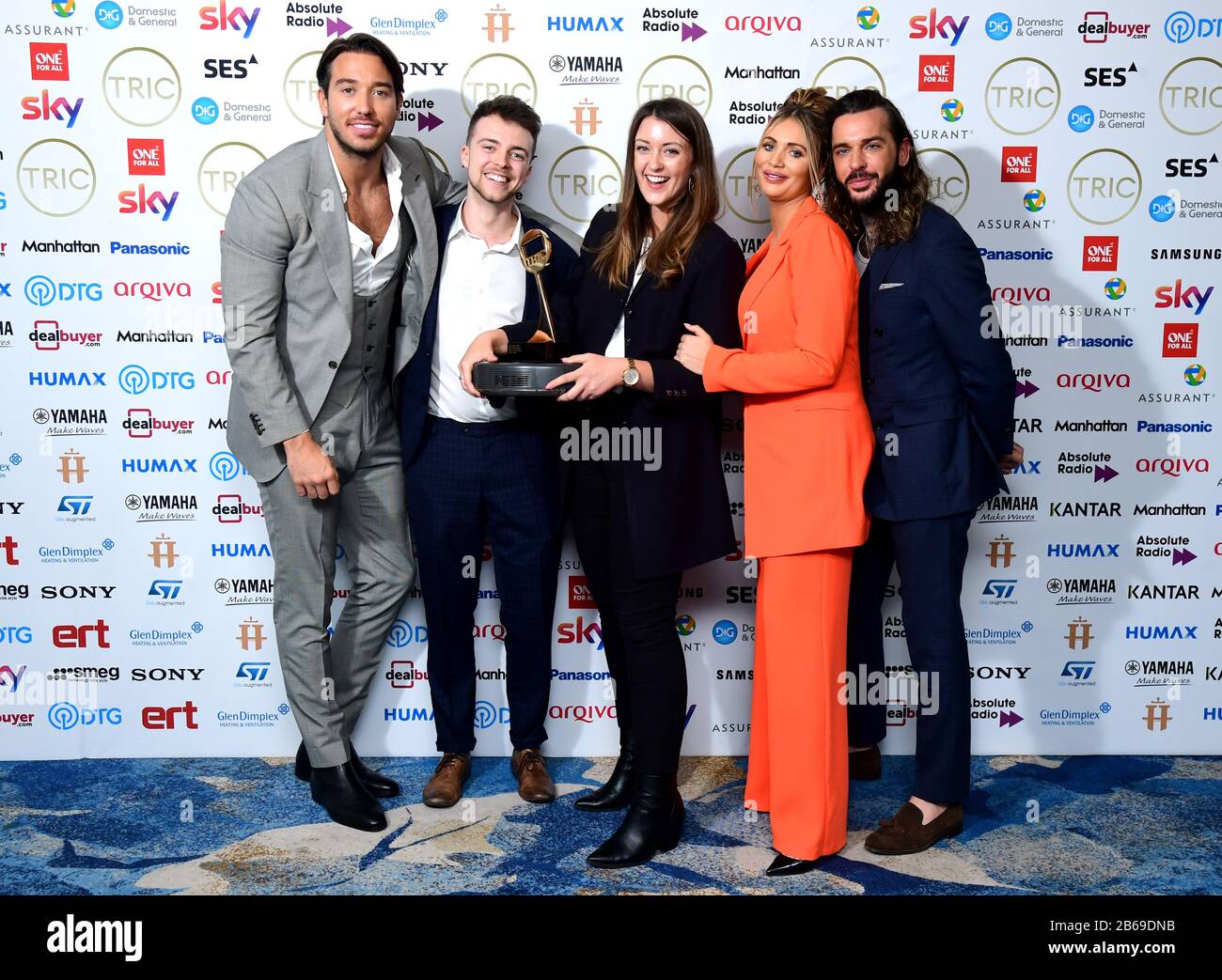 James Lock, Amy Childs and Pete Wicks (right) picks up the award for Greg James who wins the Radio Personality Award sponsored by Arqiva at the TRIC Awards 2020 held at the Grosvenor Hotel, London. Stock Photo