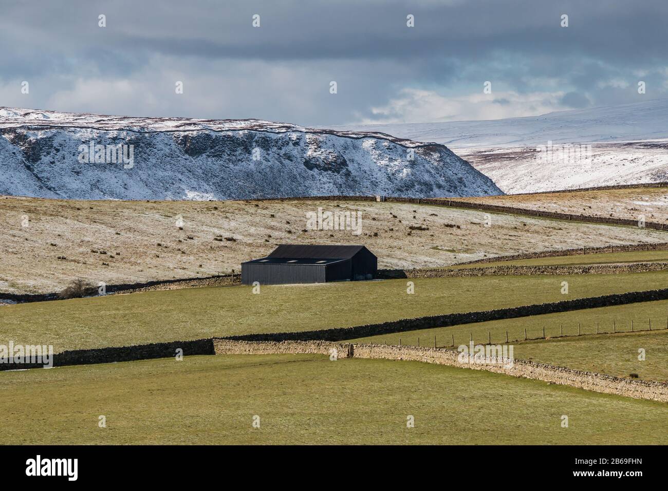 A wintry Cronkley Scar and part of Widdybank Fell from across the dale at High Beck Head, Upper Teesdale, UK Stock Photo