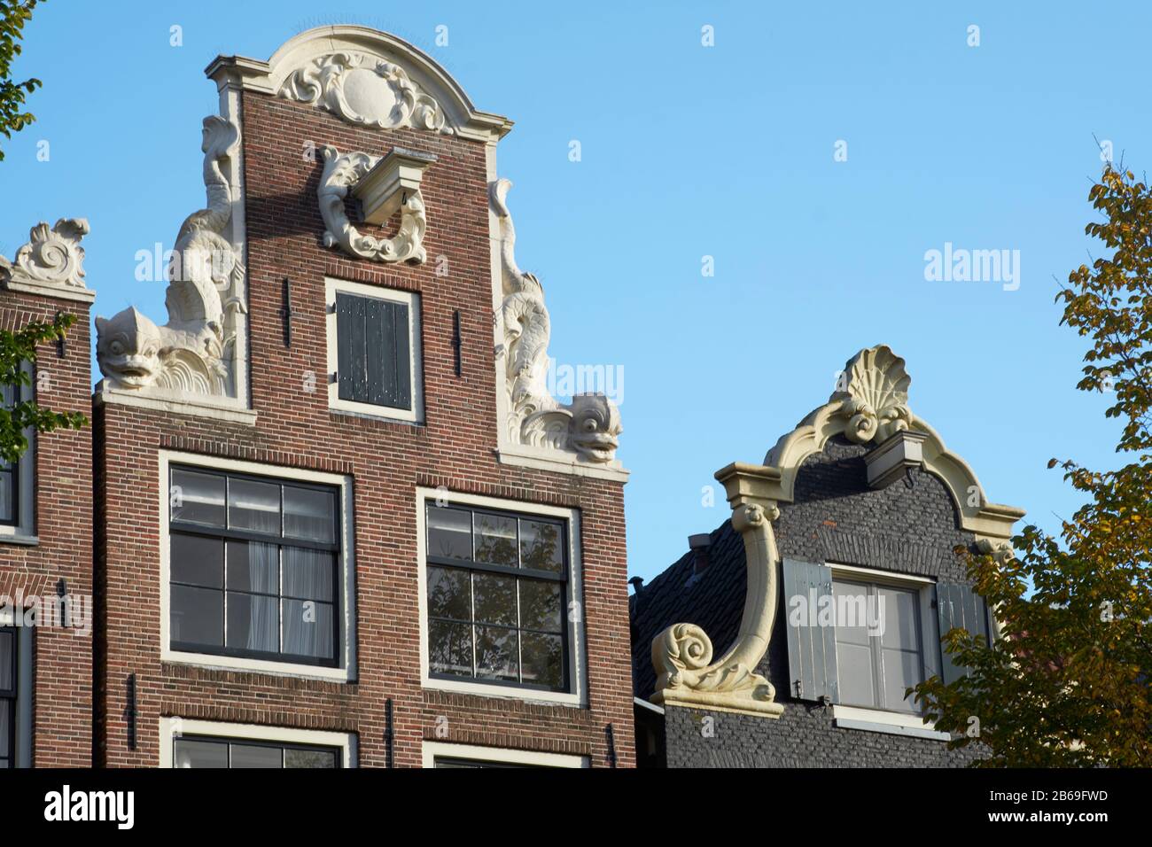 Gables on typical Amsterdam houses, with dolphins. On Brouwersgracht canal. Eighteenth centiury. Stock Photo