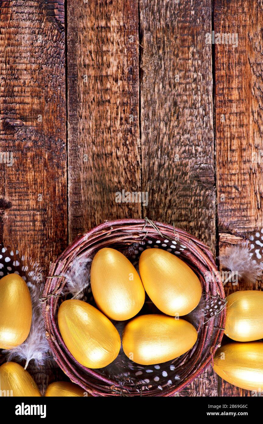 golden eggs in nest and on a table Stock Photo - Alamy