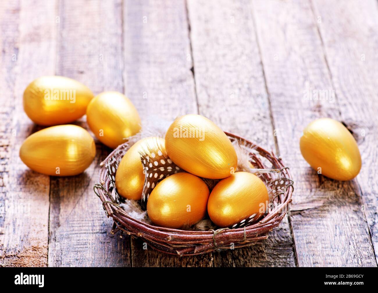 golden eggs in nest and on a table Stock Photo - Alamy