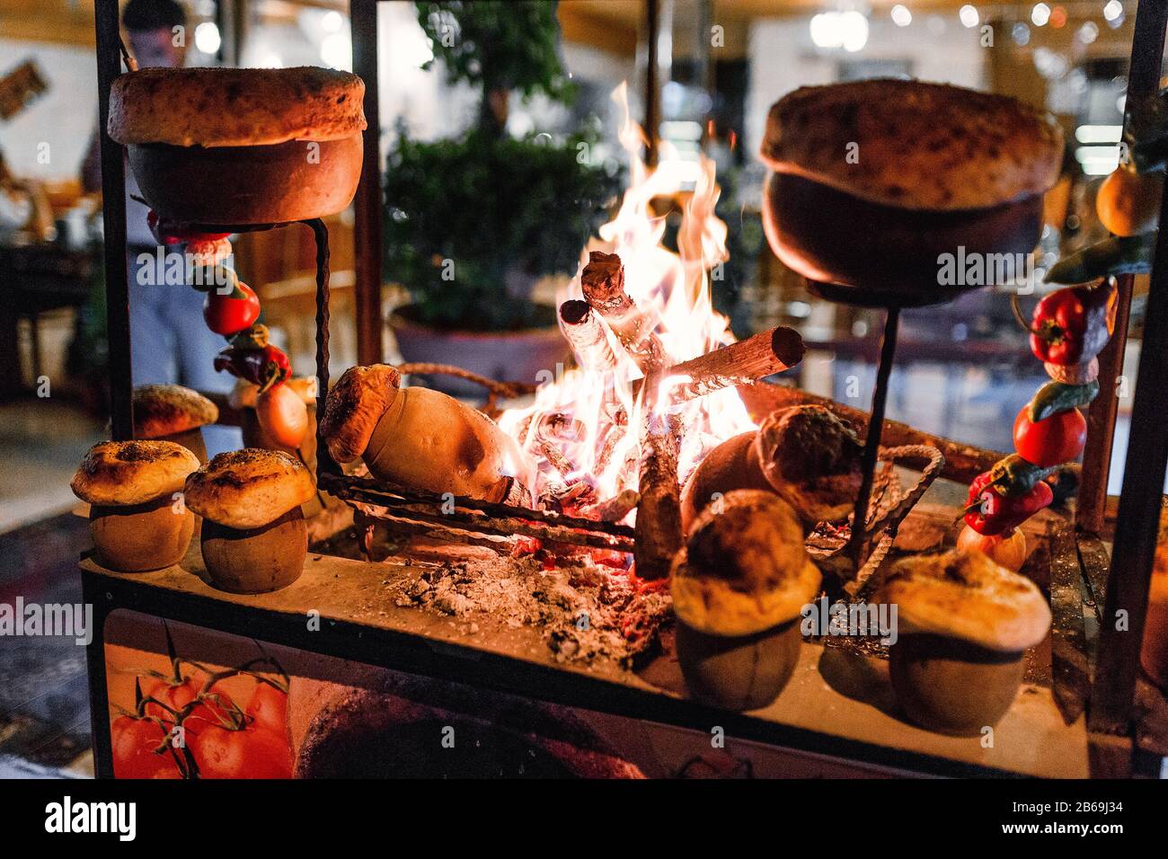 traditional Turkish Testi Kebab cooked in clay pot on open fire at night in  restaurant, authentic oriental cuisine Stock Photo - Alamy