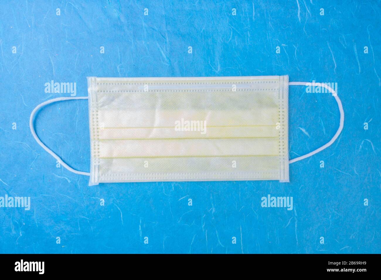 Download Yellow Surgical Mask With Rubber Ear Straps Medical Virus Mask On Medical Blue Background Protection Concep Top View Copy Space Stock Photo Alamy PSD Mockup Templates