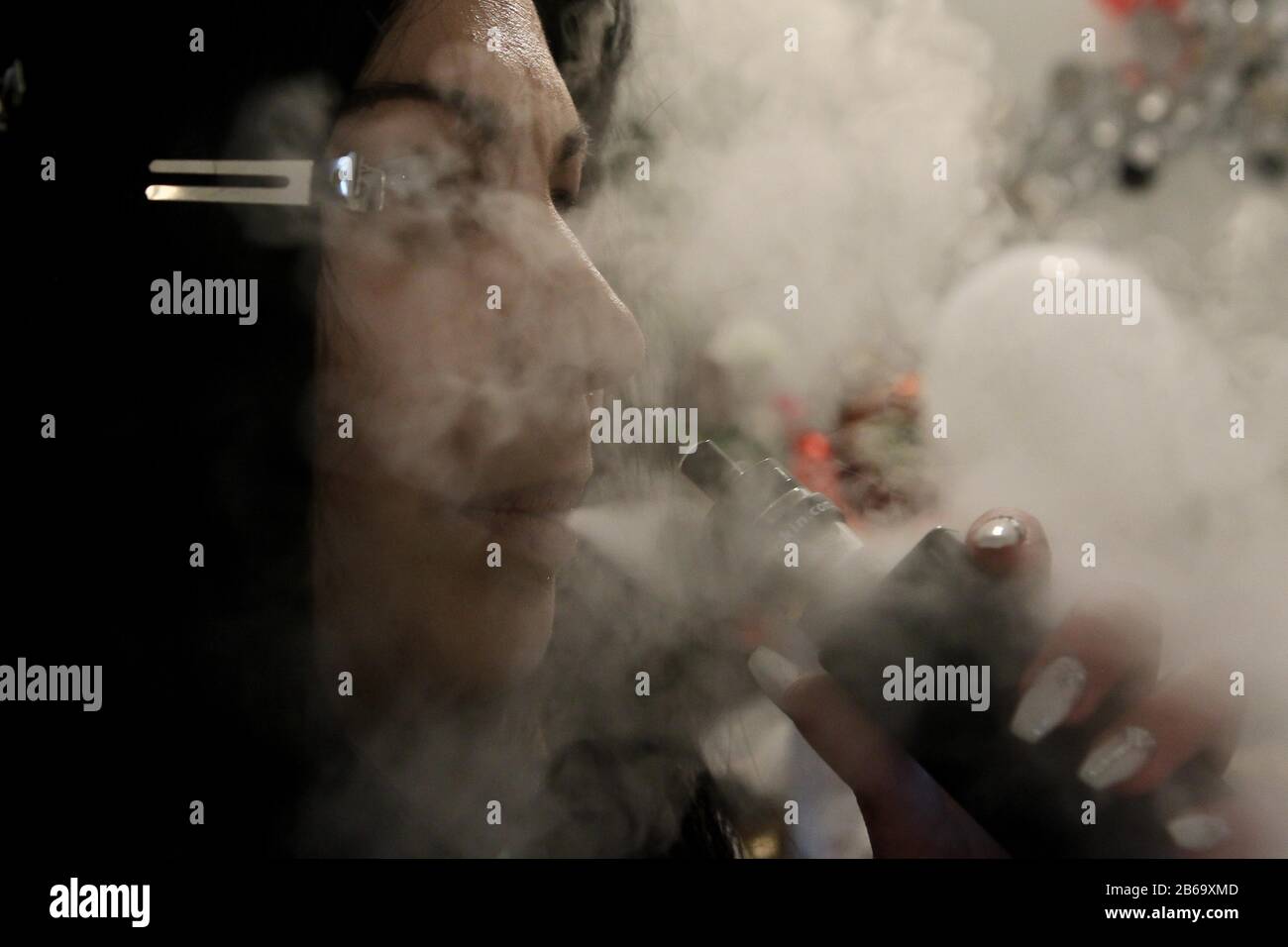 A woman smoke electronic cigarette Stock Photo