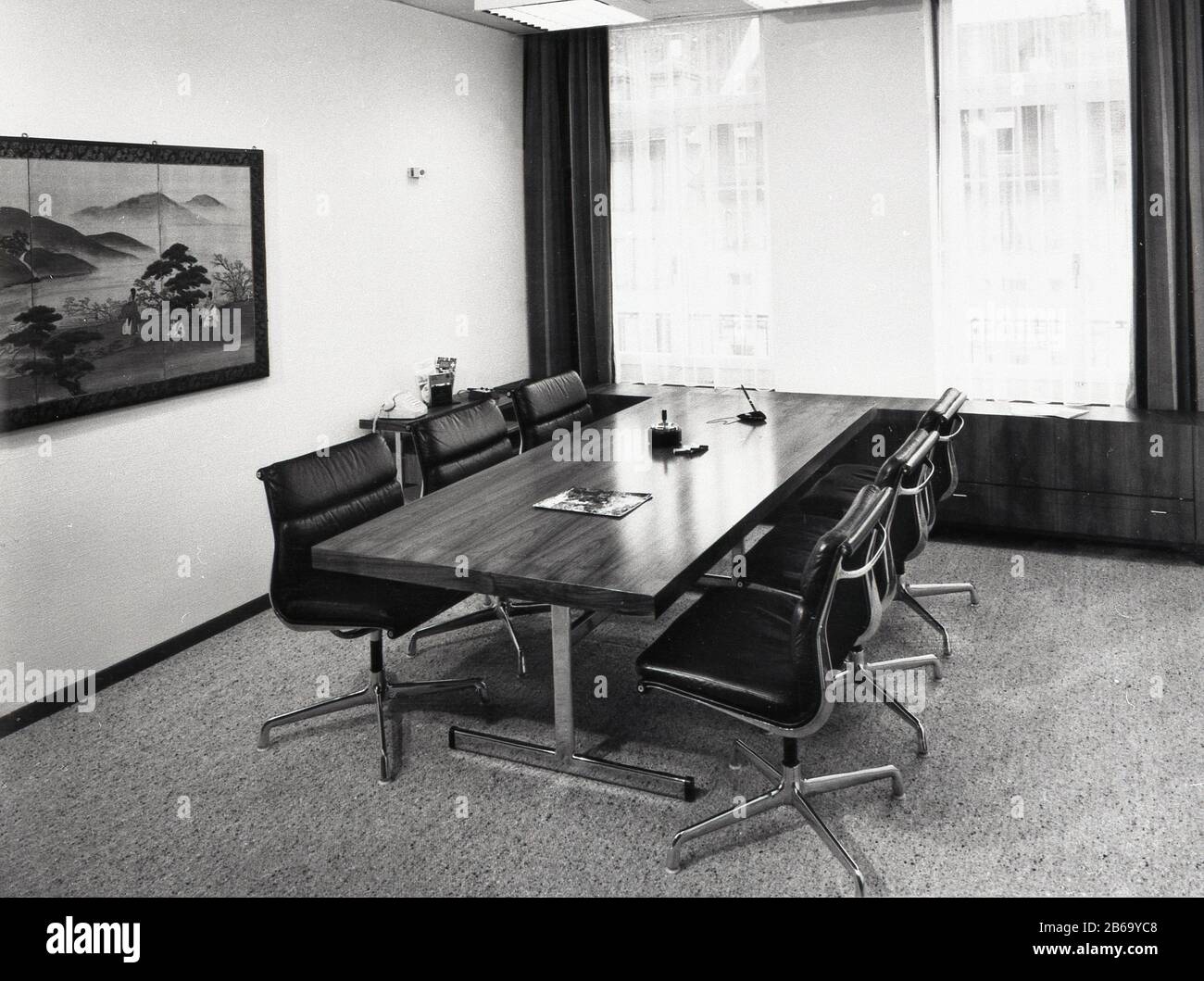 1970s, office meeting room with shiny wooden table with chrome metal legs and chrome metal swivel chairs of the era, Swiss Banking Corporation, Berne, Switzerland. Stock Photo