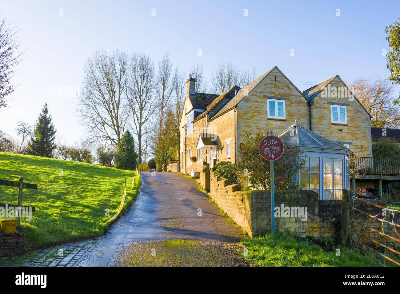 Approaching the summit of Nocketts Hill near Chippenham where former farm cottages have become comfortable dwellings in Wiltshire England UK Stock Photo