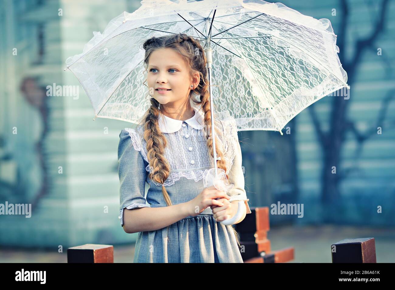 Girl in vintage dress with retro umbrella Stock Photo - Alamy