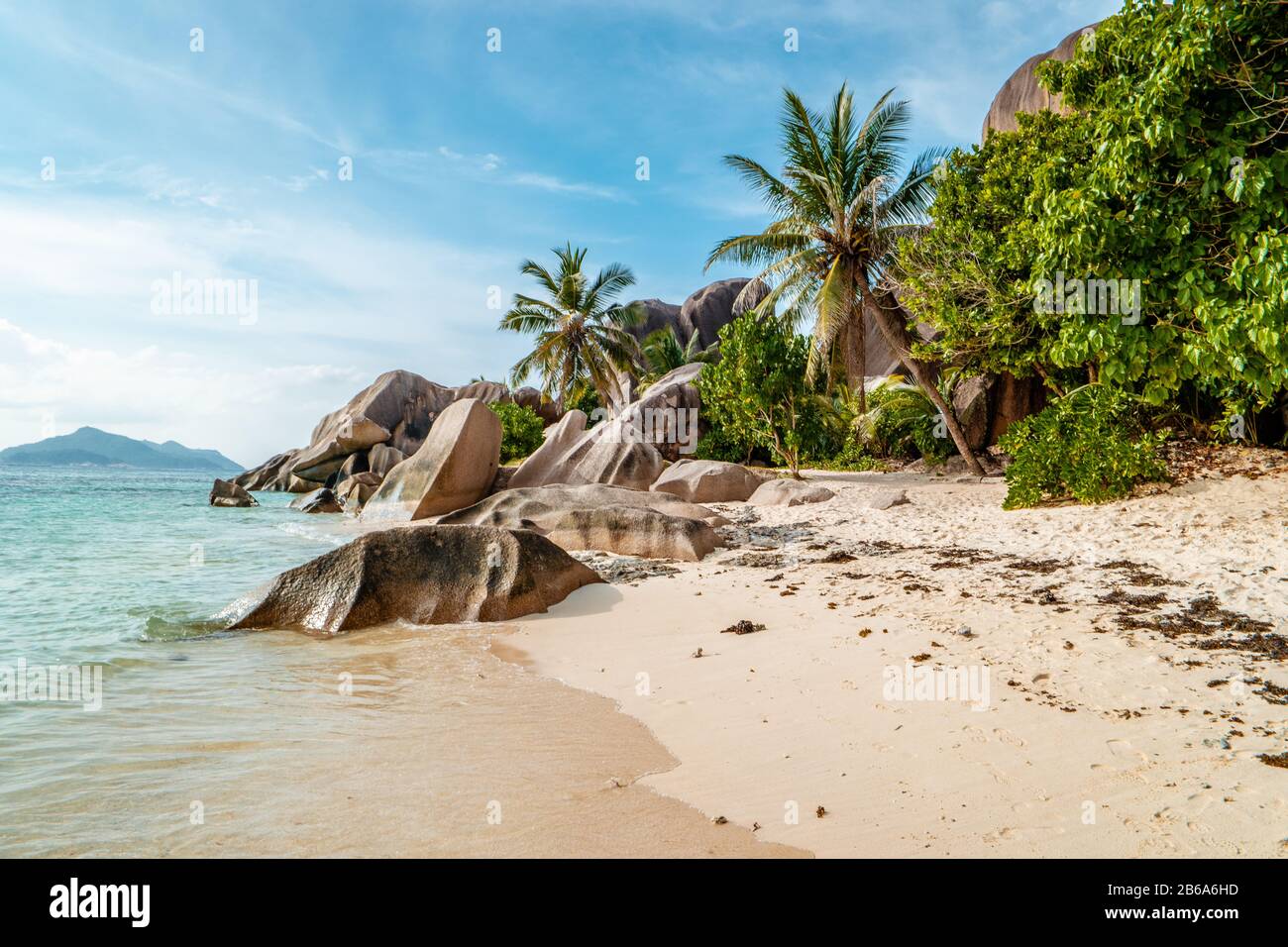 La Digue Seychelles, sunset on the white tropical beach with palm tree Stock Photo