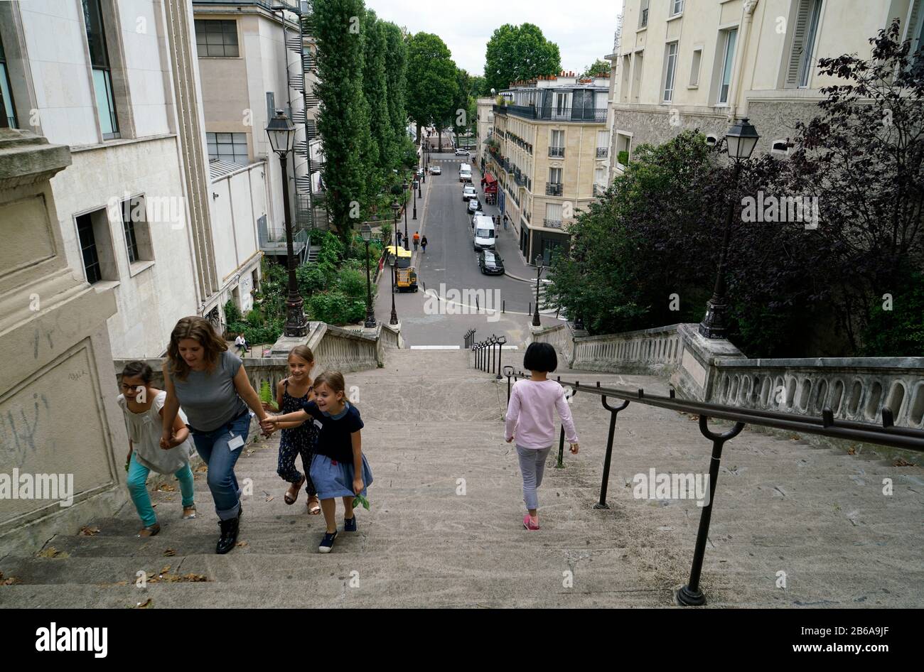 Adult and children walking on the steep Rue de la Manutention connecting River Seine and Avenue du President Wilson in 16th arrondissement.Paris.France Stock Photo