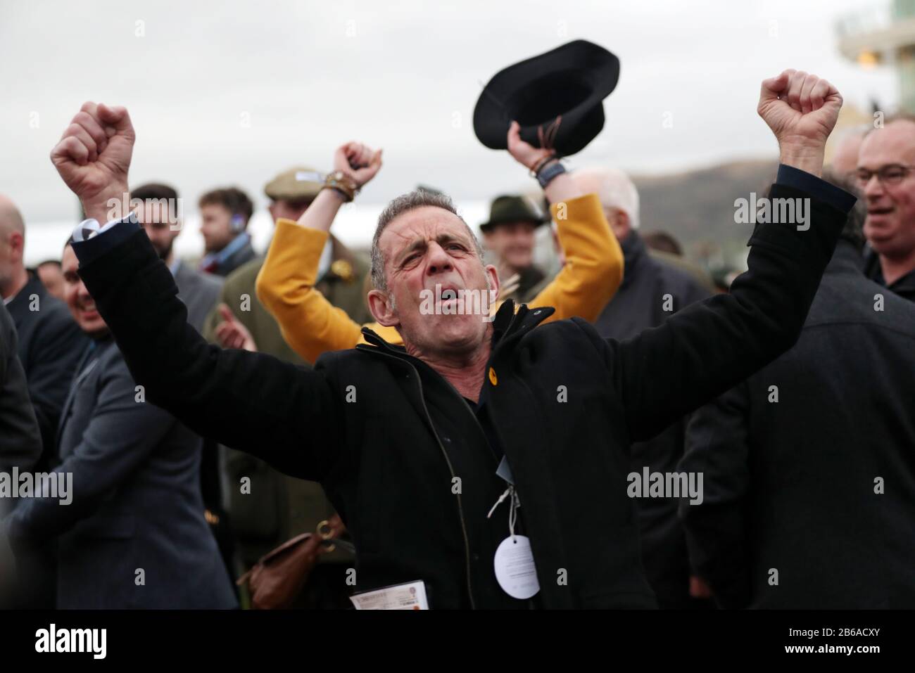 A spectator celebrates after Imperial Aura and jockey David Bass celebrate won the Northern Trust Company Novices' Handicap Chase during day one of the Cheltenham Festival at Cheltenham Racecourse, Cheltenham. Stock Photo
