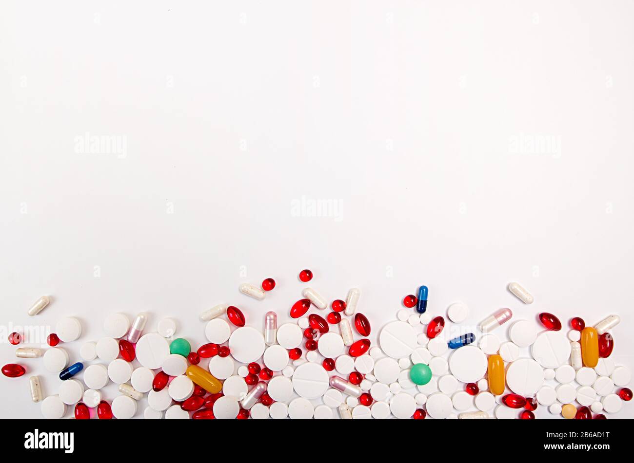 Heap of medicine tablets and pills different colors on white background ...