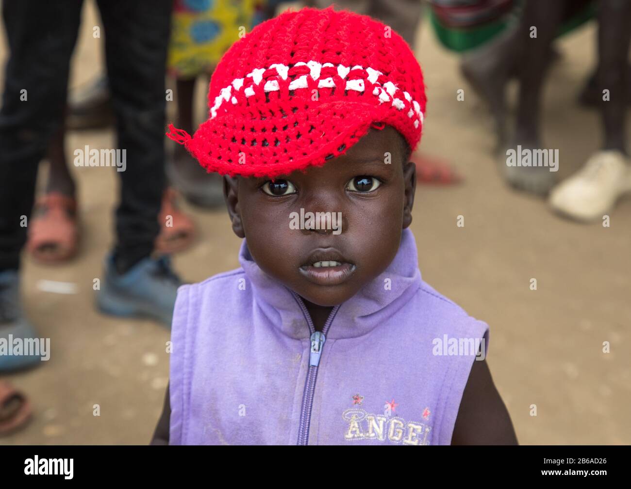 Portrait of a Toposa girl with a red Knit Hat, Namorunyang State, Kapoeta, South Sudan Stock Photo