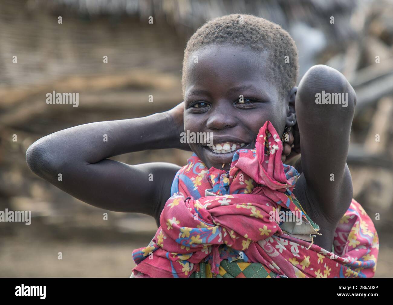 Smiling Toposa tribe girl in a village, Namorunyang State, Kapoeta, South Sudan Stock Photo