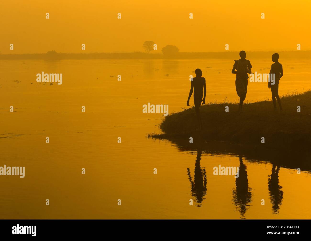 Mundari tribe people on the bank of river Nile at sunset, Central Equatoria, Terekeka, South Sudan Stock Photo