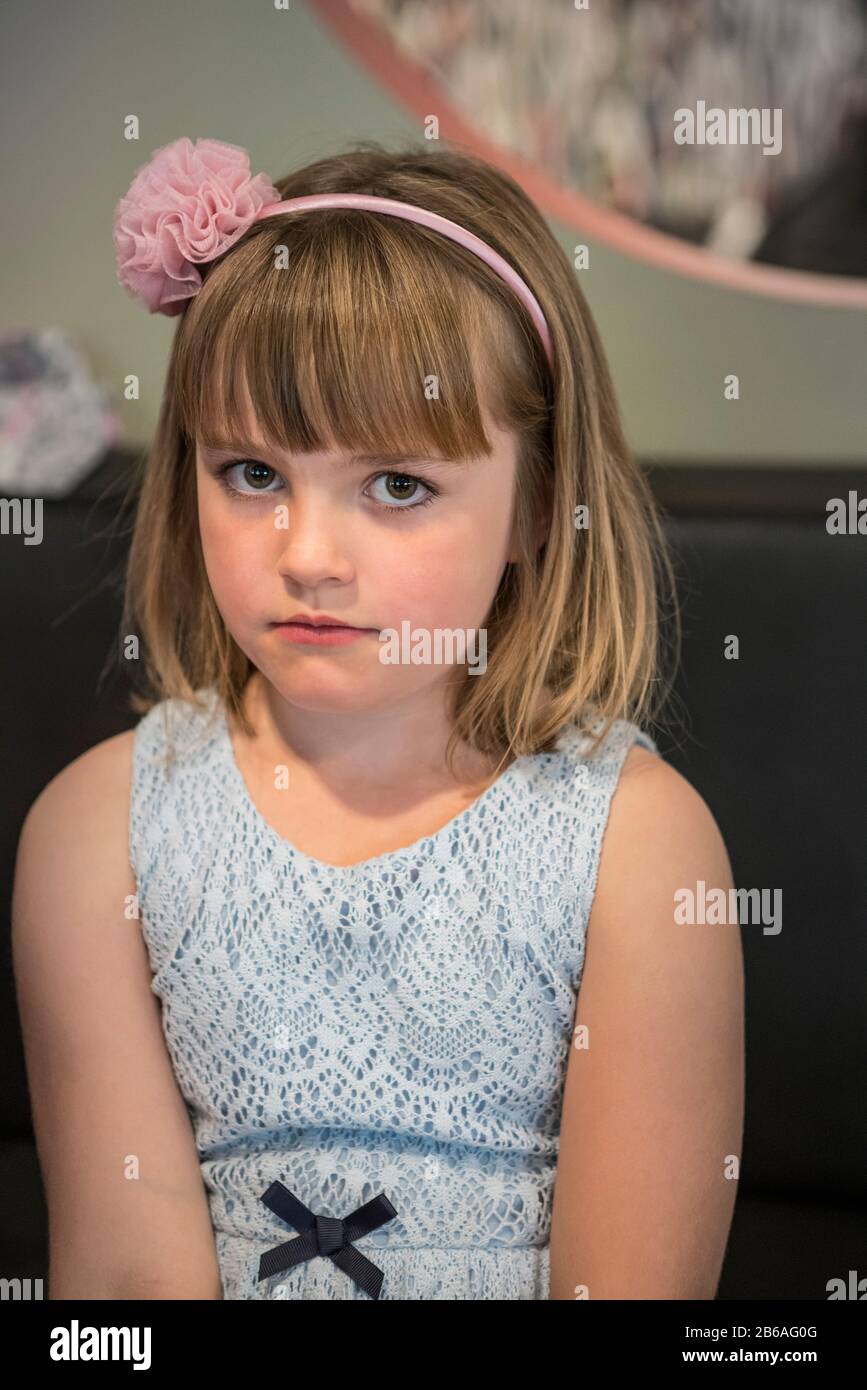 Portrait of a shy smiling girl in a dress Stock Photo