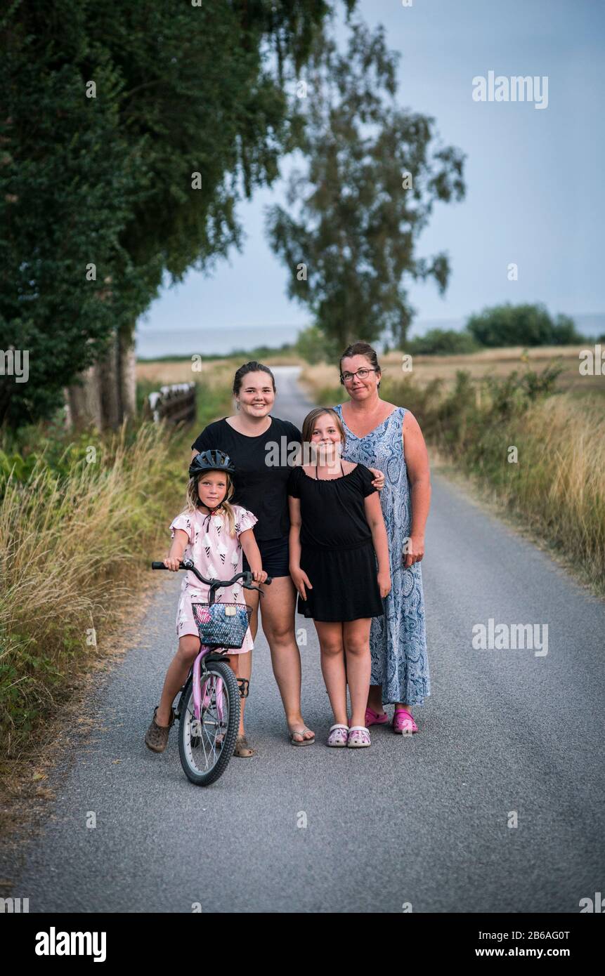 Woman with 3 children on a rural country road Stock Photo