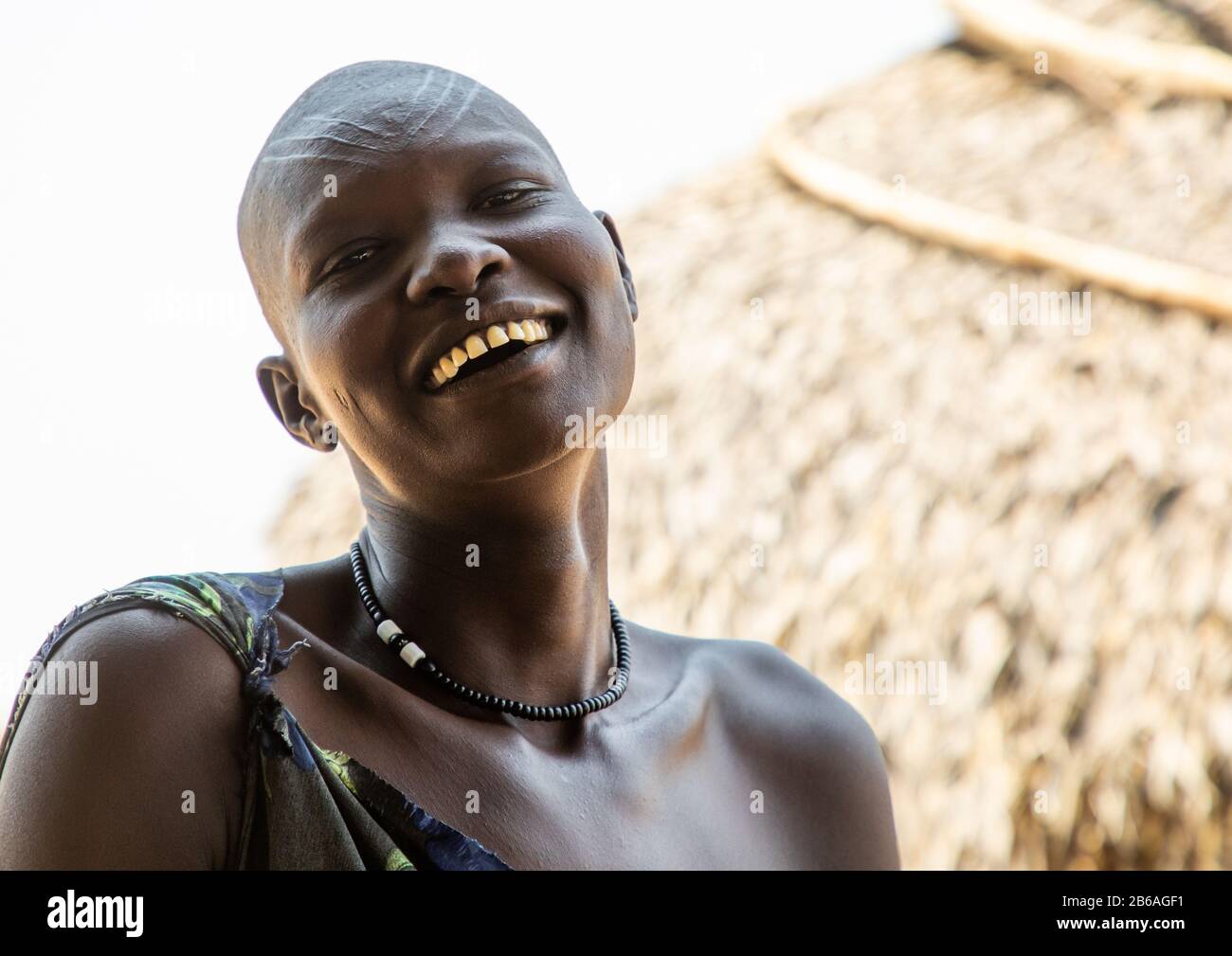 Portrait of a smiling Mundari tribe woman with scarifications on the forehead, Central Equatoria, Terekeka, South Sudan Stock Photo