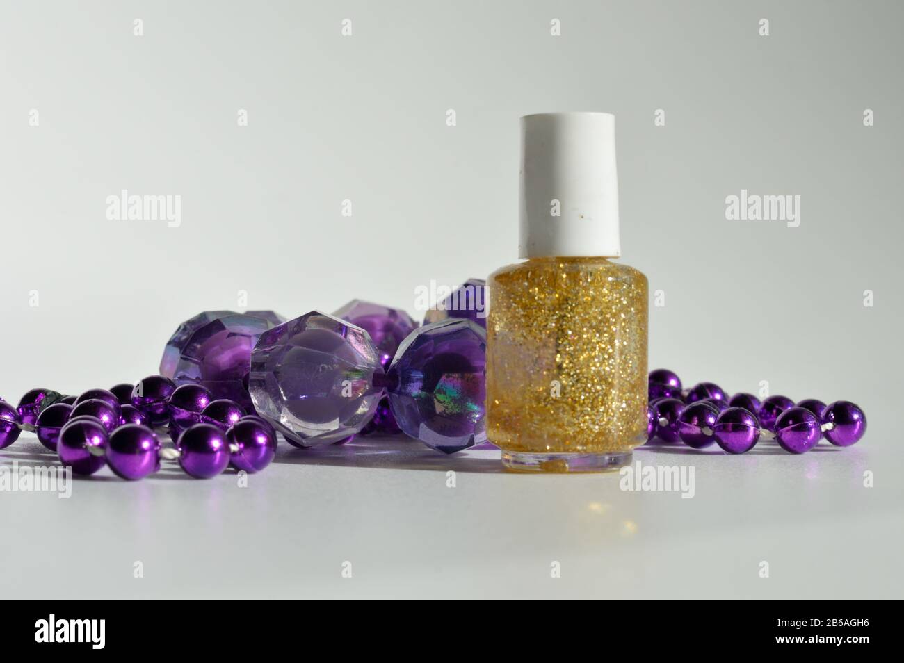 Purple dress with gold necklace hi-res stock photography and images - Alamy