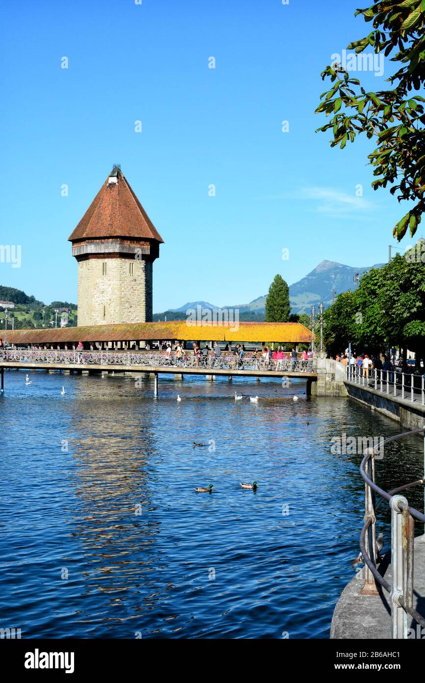 LUCERNE, SWITZERLAND - July 4, 2014: Chapel Bridge or Kapellbrücke is the oldest wooden covered bridge in Europe. The 170 meter bridge spans the Reuss Stock Photo