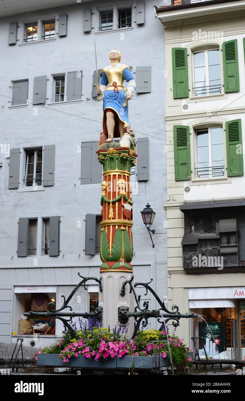 LAUSANNE, SWITZERLAND - JULY 7, 2014: The Fountain of Justice (Fontaine de la Justice). The fountain dates from 1557, and the original statue, made in Stock Photo