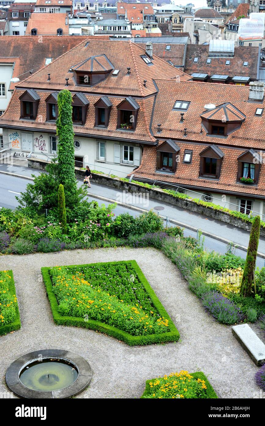 LAUSANNE, SWITZERLAND - JULY 7, 2014: Gardens and city view at the Cathedral of Notre Dame of Lausanne. The church belongs to the Evangelical Reformed Stock Photo