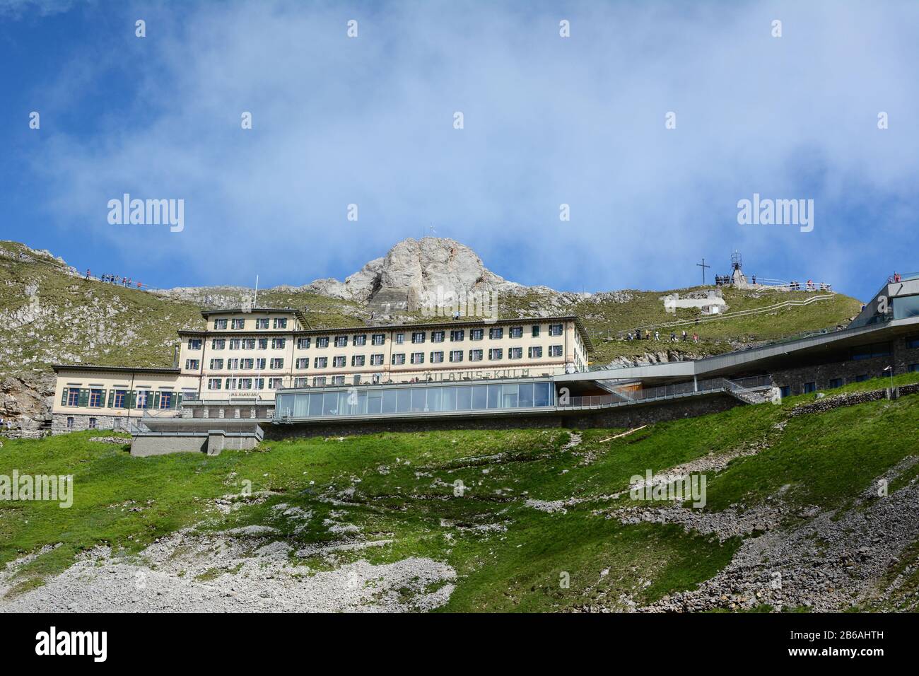 ALPNACHSTAD, SWITZERLAND - July 3, 2014: The Hotel Pilatus-Kulm, first opened in 1890, stands atop  Mount Pilatus in the Swiss Alps. Viewed from the P Stock Photo