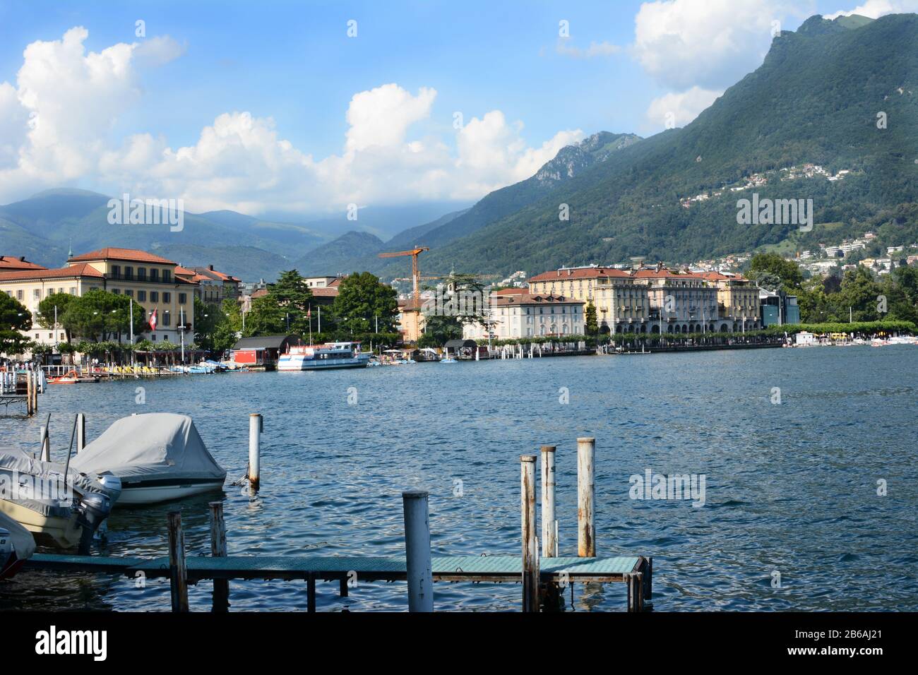 LUGANO, SWITZERLAND - JULY 5, 2014: Lugano city and shoreline.The affluent city in southern Switzerland sits on the shores of Lake Lugano a popular to Stock Photo