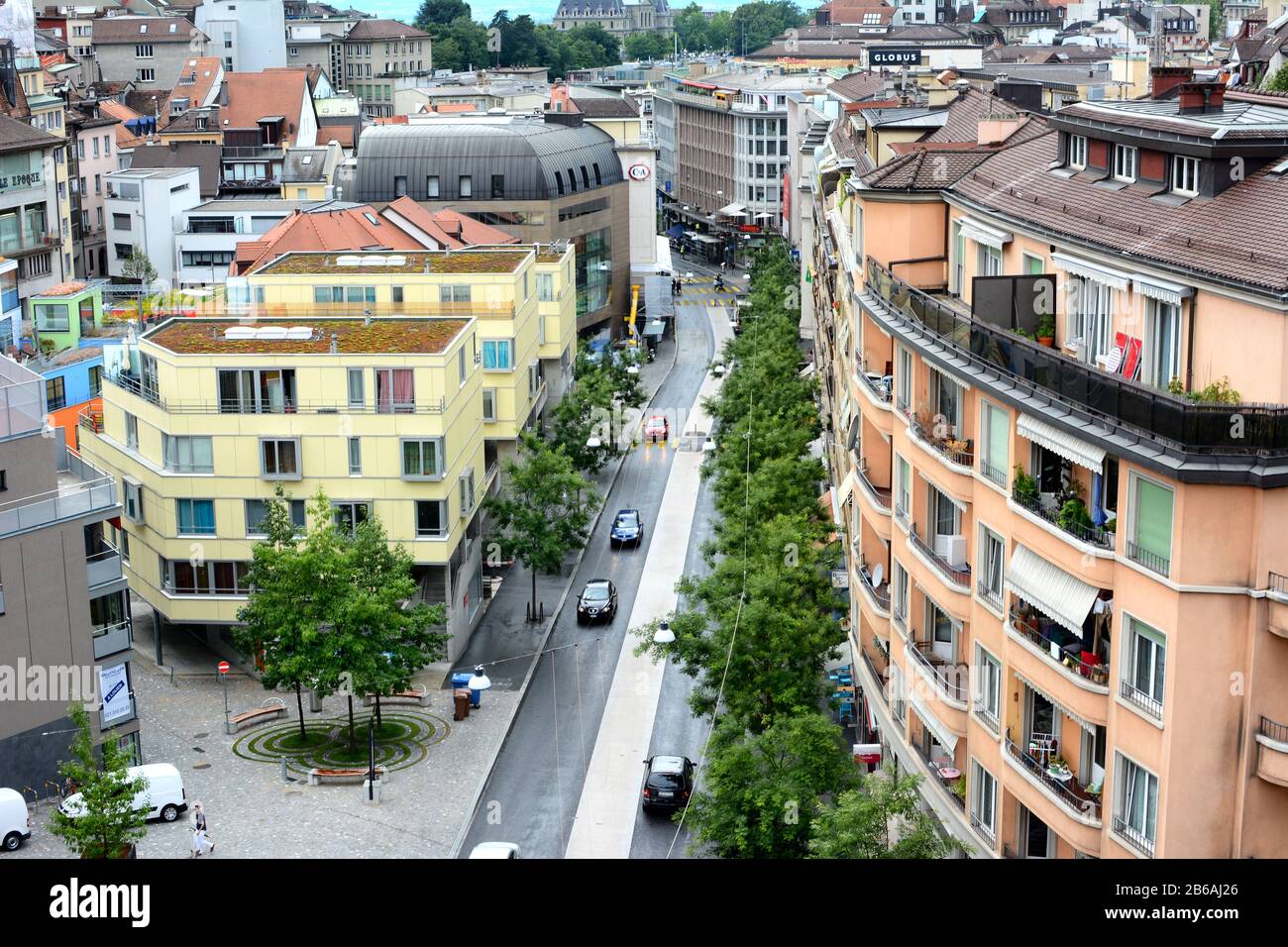 LAUSANNE, SWITZERLAND - JULY 7, 2014: City street, Lausanne, Switzerland. The high angle view shows the roof tops and street of a typical Swiss city. Stock Photo