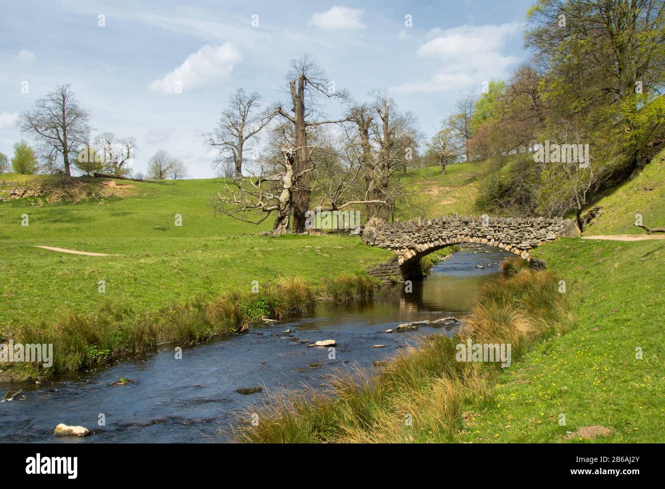 Small stone bridge over The River Skell, Studley Royal, Ripon, North ...