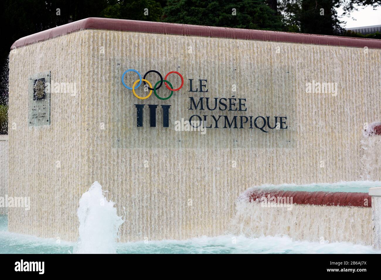 LAUSANNE, SWITZERLAND - JULY 5, 2014: Fountain and Sign at the Olympic Museum. The Museum has more than 10,000 pieces and hosts over 250,000 visitors Stock Photo