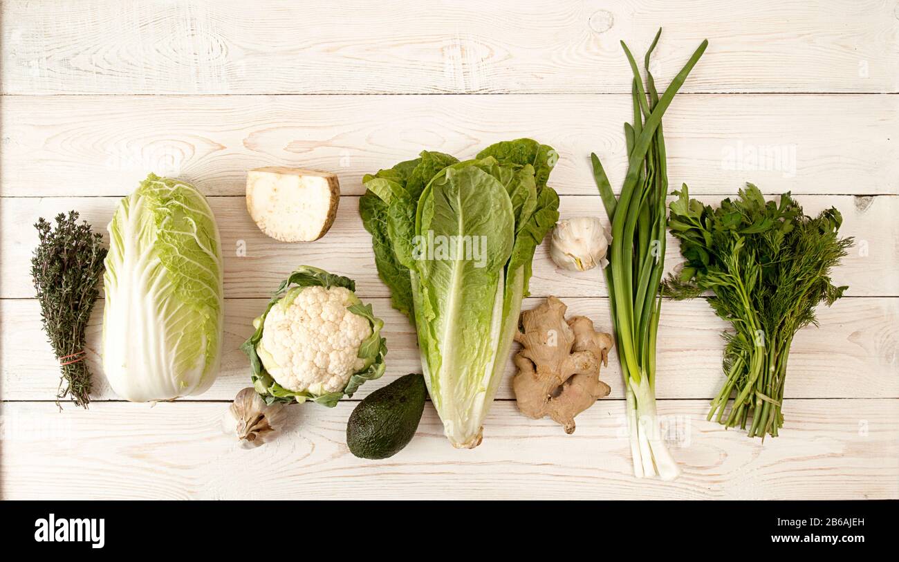 Raw of green and white fresh organic vegetables thyme, cabbage, celery