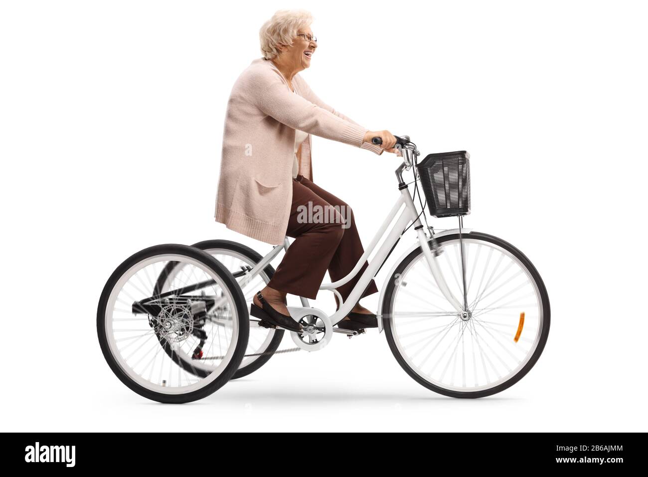 Elderly lady riding a tricycle isolated on white background Stock Photo