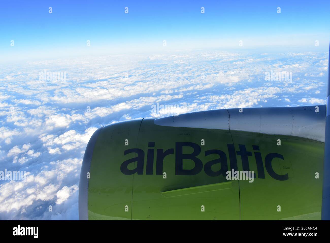 Riga, Latvia - April 22, 2019: View from plane window on turbine. Airbaltic airplane flying over the clouds Stock Photo