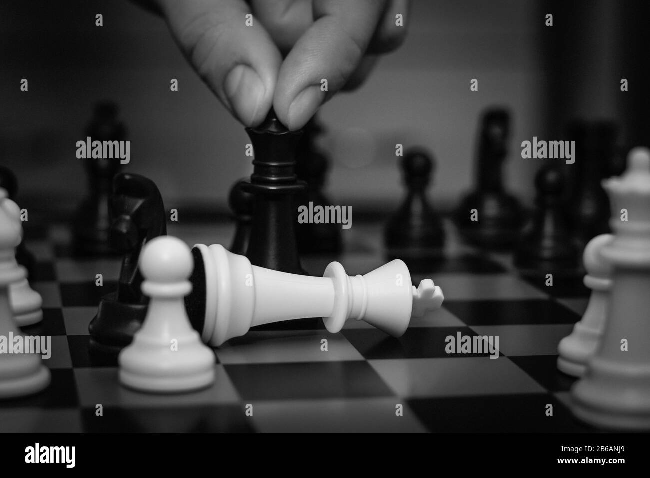 Chess board game concept for ideas and competition and strategy, business success concept.Businessman playing chess close up. Stock Photo