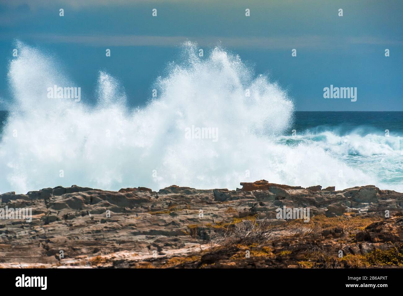 An enormous wave crashing against the rocks at Storms River Mouth, Tsitsikamma National Park, South Africa Stock Photo