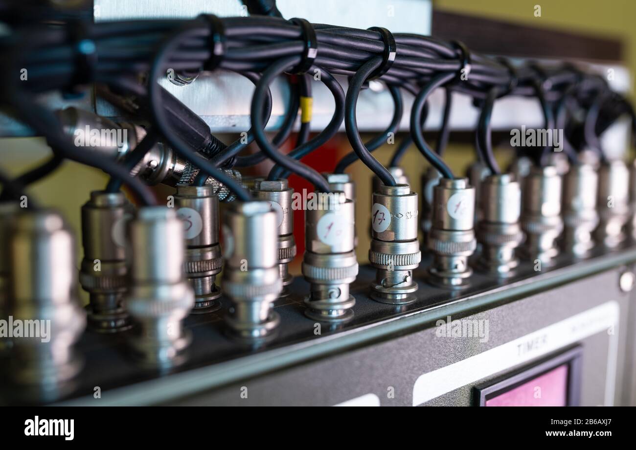 Close-up side view of a wire and a numbered plugs connected to each ...