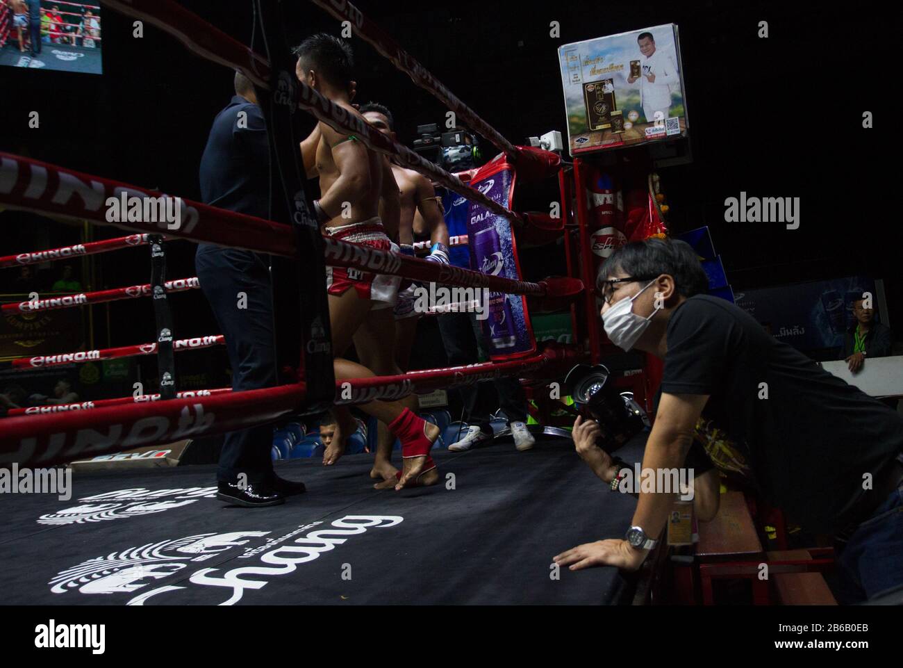 A photographer wearing a face mask during the Thai Boxing match that ...