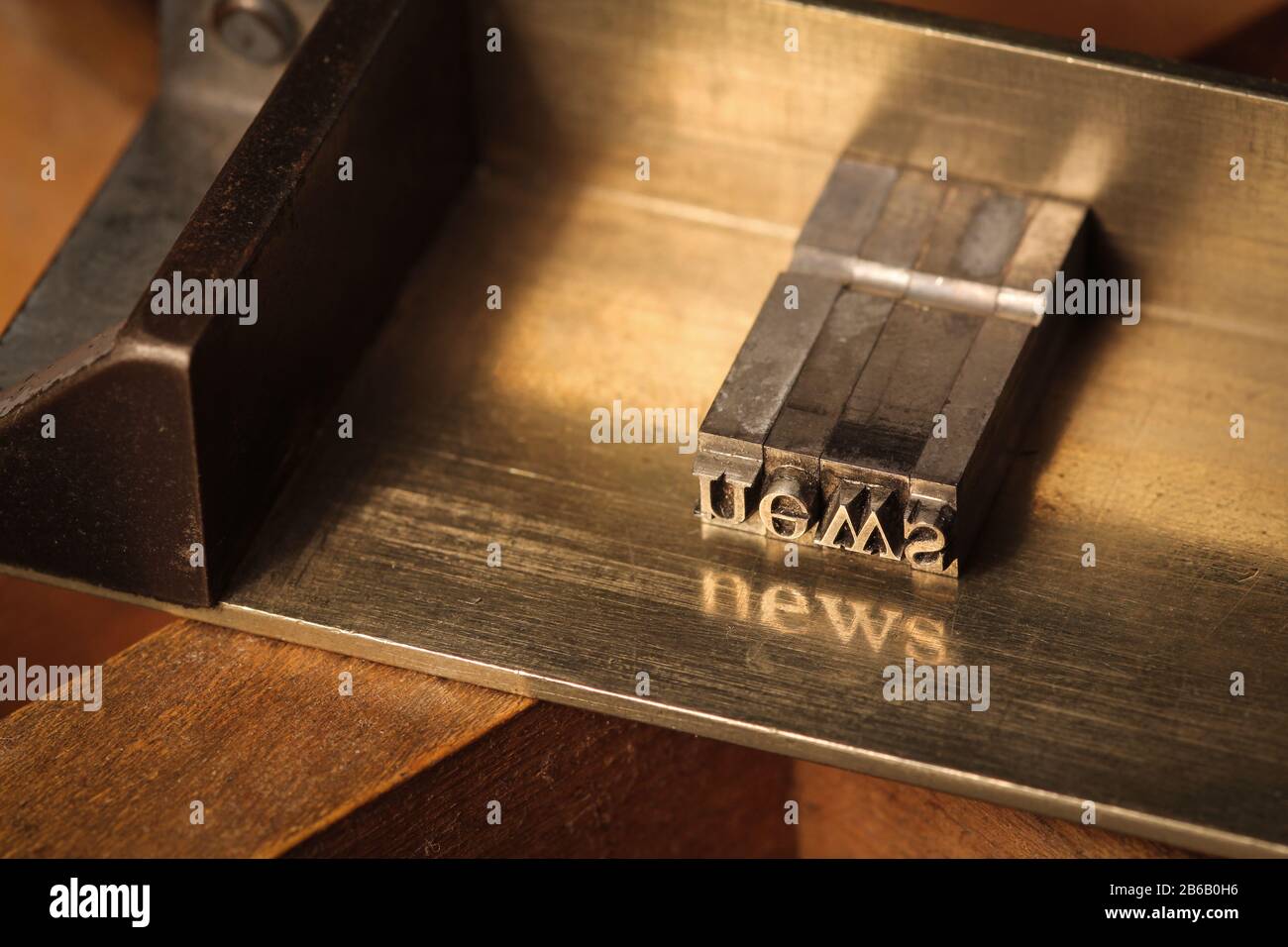 Composing stick with the letters 'news' Stock Photo