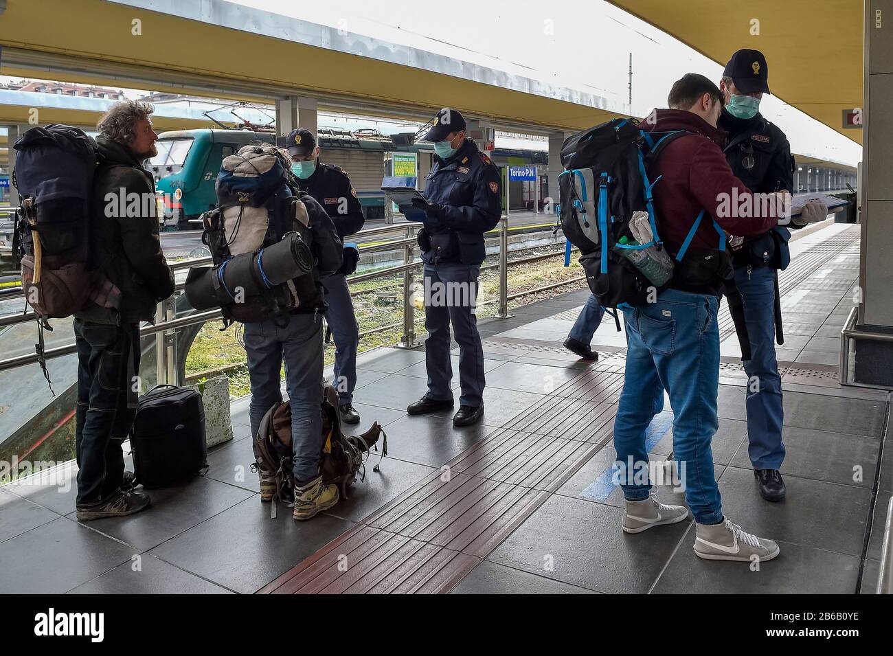 Turin, Italy. 09th Mar, 2020. TURIN, ITALY - March 09, 2020: Police officers check passengers leaving from Turin Porta Nuova train station. The Italian government imposed a virtual lockdown on the north of the country as part of measures to stop the spread of the coronavirus COVID-19 outbreak in Italy. (Photo by Nicolò Campo/Sipa USA) Credit: Sipa USA/Alamy Live News Stock Photo
