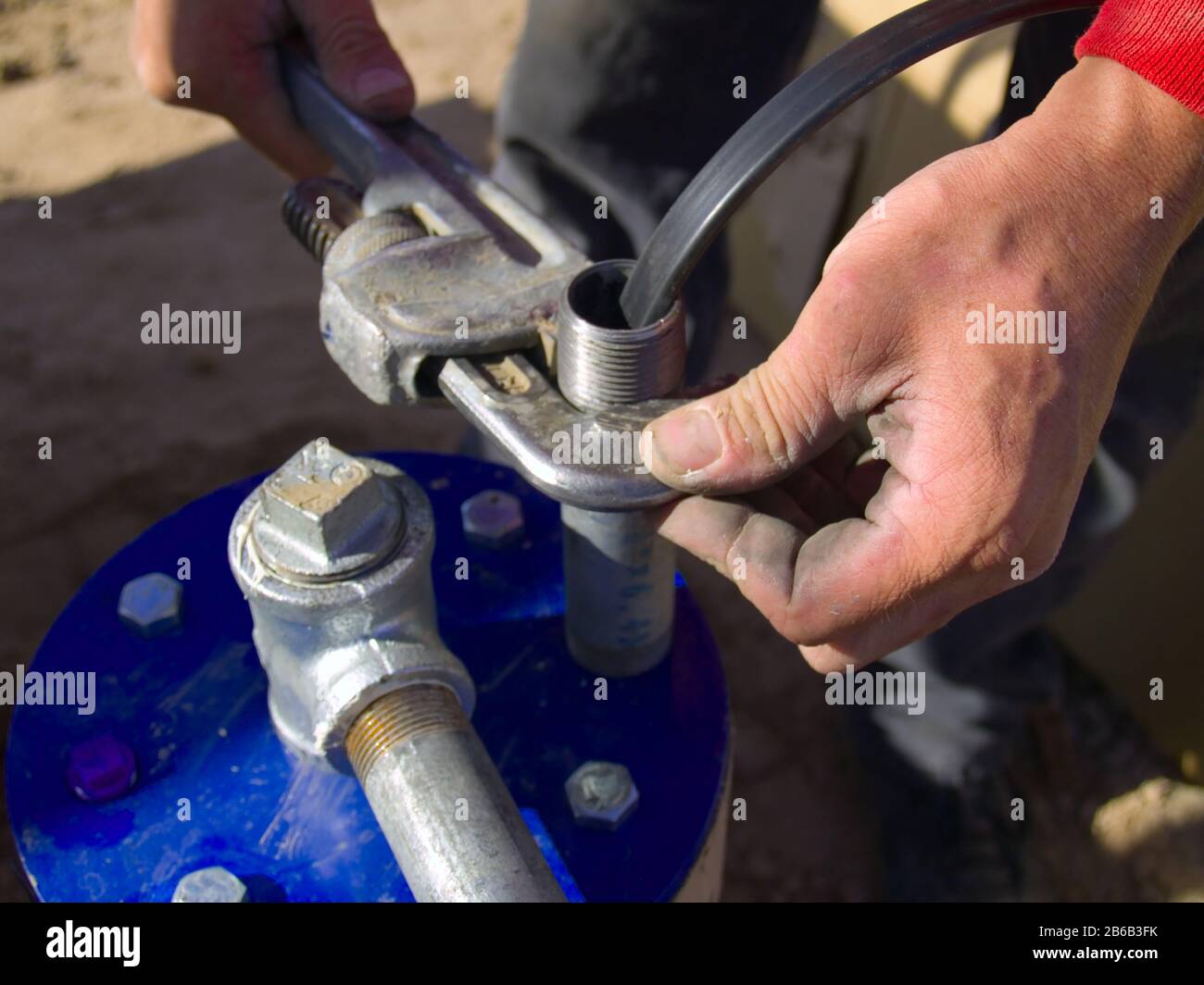 A connection being made between the pipe of a Well Pump and the