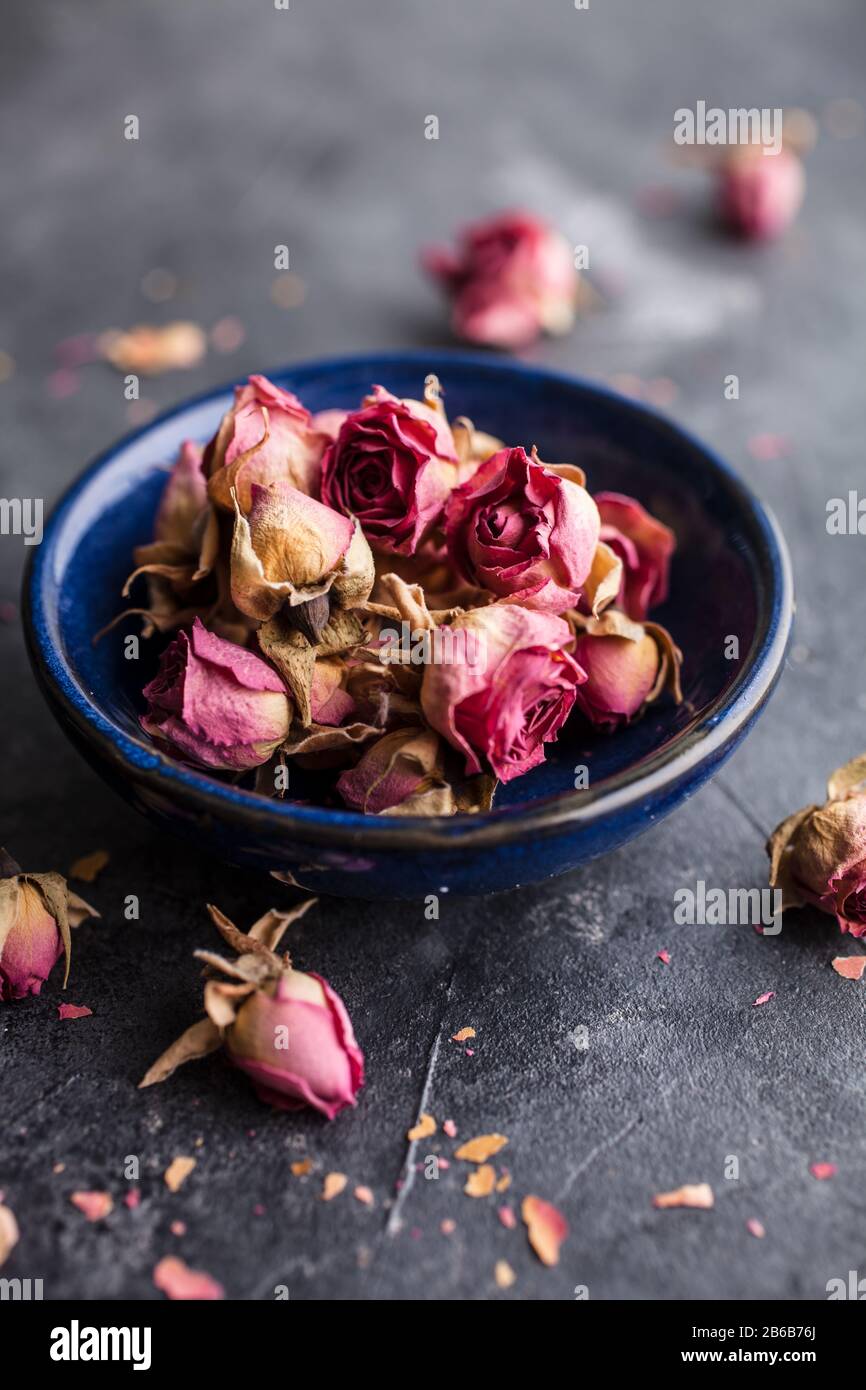 Dried pink rose buds on dark background Stock Photo